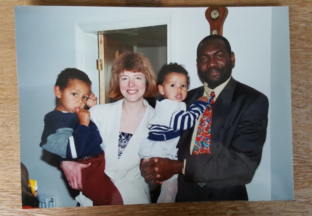 My mum holding my older brother who is sucking his thumb, and my dad holding me when I was a baby.